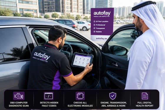 Inspector kneeling at open driver door plugging OBD scanner cable into port under steering column, blue LED on connector glowing, bright Dubai daylight flooding cabin