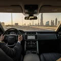 Inspector driving SUV on wide Dubai highway, hands at ten and two, Burj Khalifa skyline ahead, golden hour warm light, dashboard gauges visible