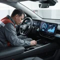 Inspector sitting in EV cockpit checking battery health screen showing 94 percent and 380km range, regenerative braking graph, bright modern display