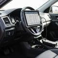 View from passenger side, scanner plugged in under dash with cable running to tablet on steering wheel, freeze frame data table on screen, bright cabin light from open door
