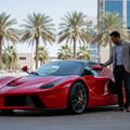Inspector locking car with fob then checking mirror auto-fold, both mirrors tucking in simultaneously, bright Dubai outdoor parking afternoon