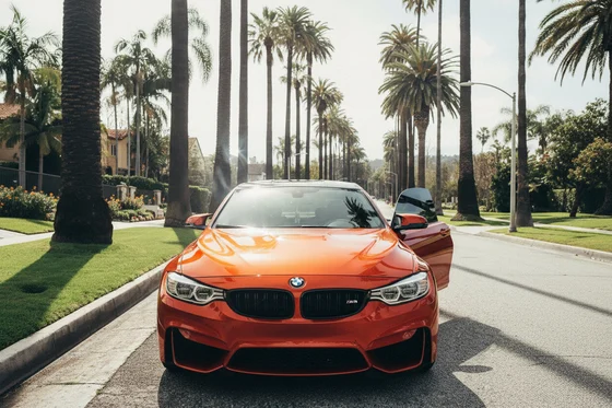 Inspector pressing all four window buttons simultaneously from driver seat, windows going down together, bright Dubai outdoor light flooding in