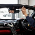 Close-up of inspector checking seatbelt retractor pull and release, buckle clicking, shoulder anchor visible, bright interior from open door